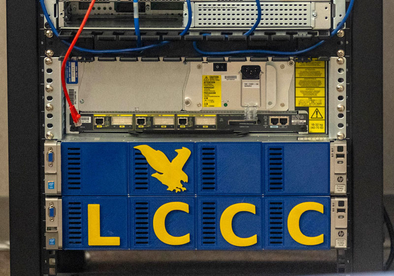 Photo of the back of a computer with wires and inputs as well as LCCC