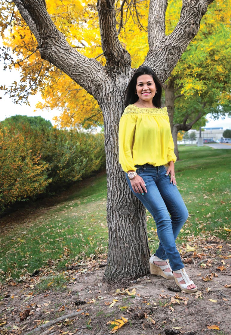 Maira Marcum standing by tree