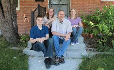 Father Doug McGee sitting with his three children