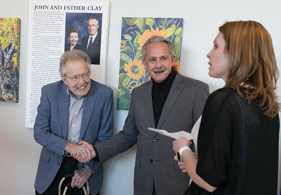 John Clay (left) shakes the hand of Jim Casey, the general manager of Halladay Motors. Casey and his company established a scholarship for LCCC students in honor of Clay. Looking on is Lisa Trimble, Associate Vice President of Institutional Advancement.