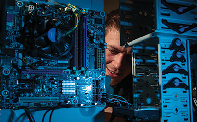 student working on computer parts