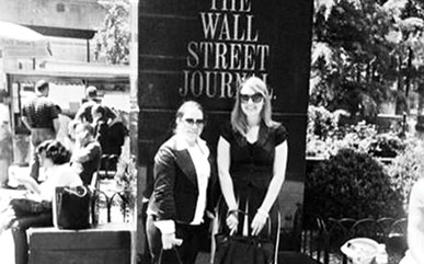 former LCCC students in front of Wall Street Journal sign