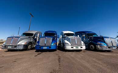 Line of four semi trucks