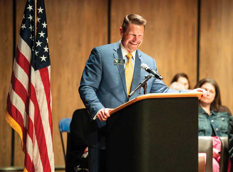 LCCC President Dr. Shaffer speaking at a podium with a US flag next to him