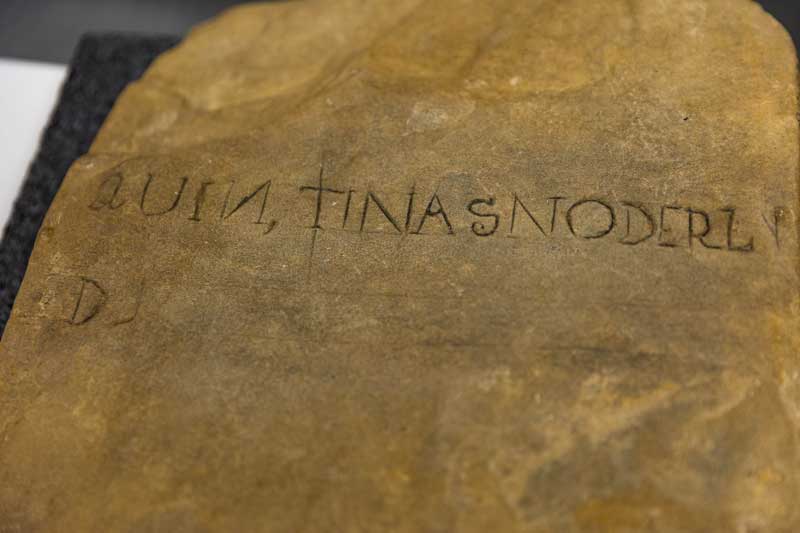 Close up of a grave stone grave marker with carvings