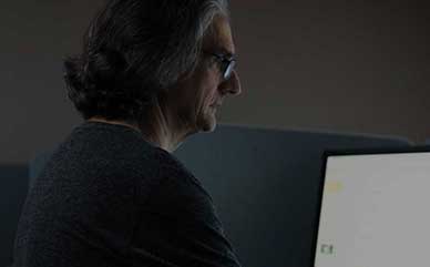 a student looking at a computer monitor