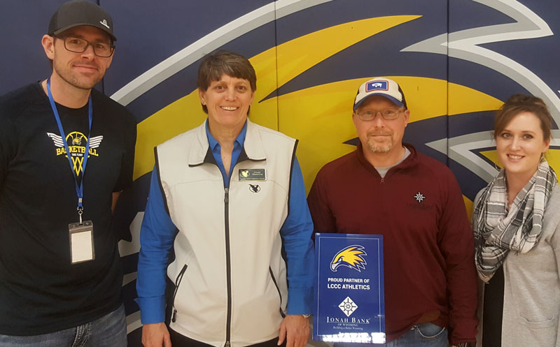 Staff from Jonah Bank with LCCC Athletics Staff with donor award sign