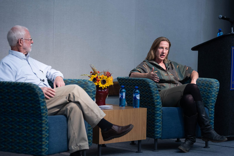 True crime writer Ron Franscell sitting on stage with novelist Christine Carbo for the 2022 Literary Connection