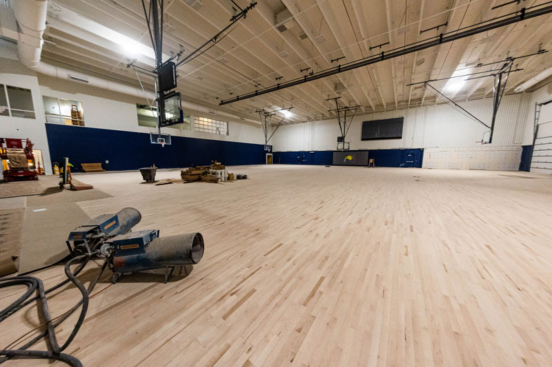 Photo of the RAC construction putting in the wood floor in the competition gym