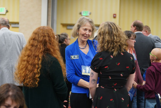 photo of donors and students talking at the scholarship luncheon