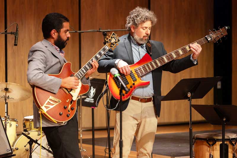 performers in the Afro Caribbean Jazz band performing with guitars on stage