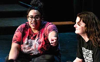 actors from Second City talking with students on stage