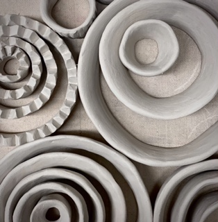 Circular clay artwork by Bronwyn Minton