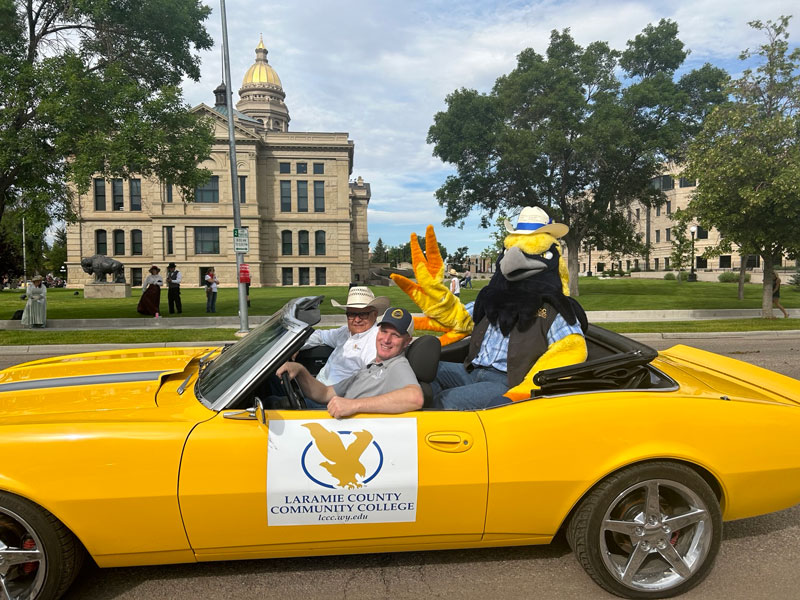 Talon the mascot riding in a car for the Cheyenne Frontier Days parade