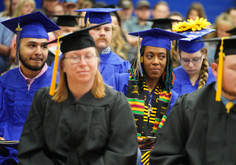 Photo of commencement with a student with international stole on 