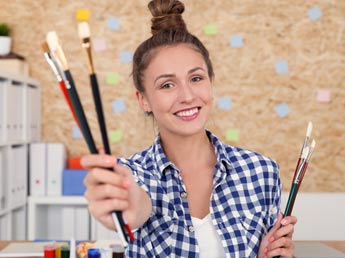 Girl handing you paintbrushes