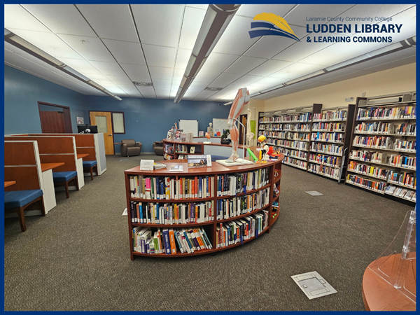 Circular bookshelf in Laramie Campus library with Ludden library logoin upper right corner.