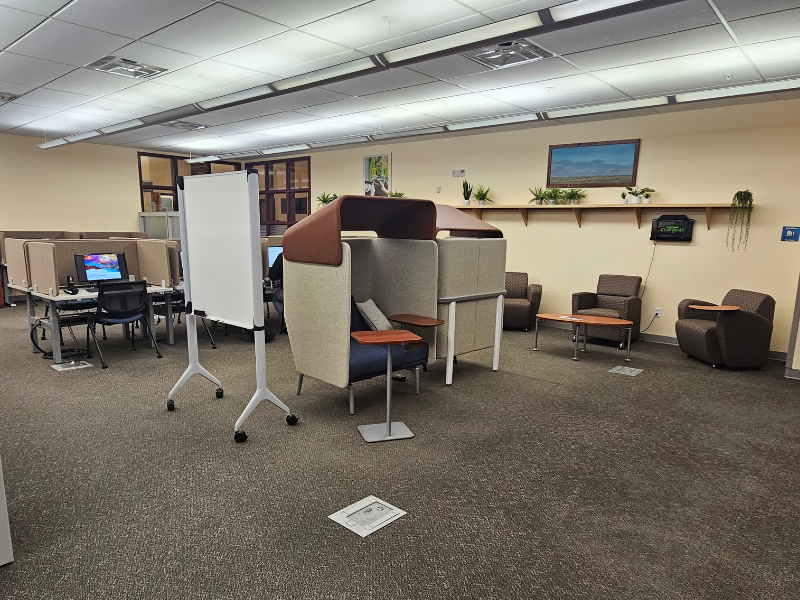 Corner view of study pods and chairs and table nook