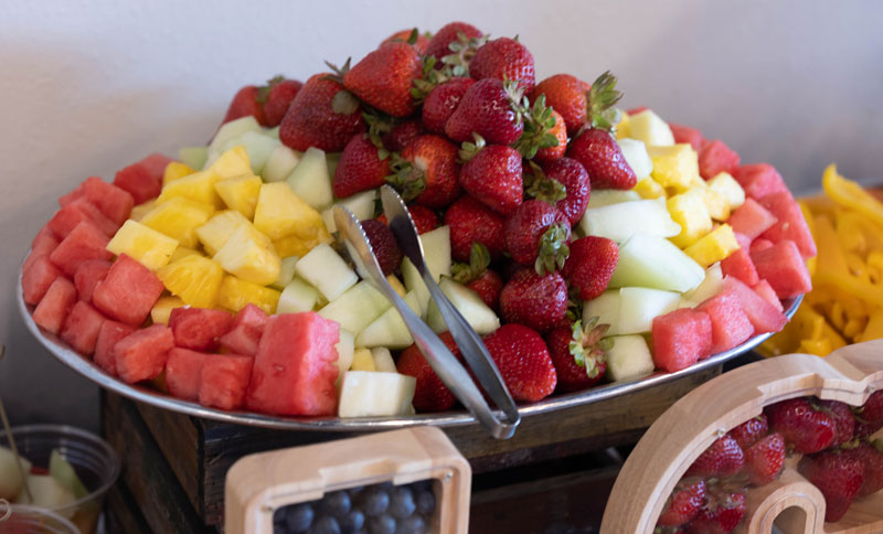 photo of a platter of cut fruit: watermelon, pineapple, honeydew and strawberries