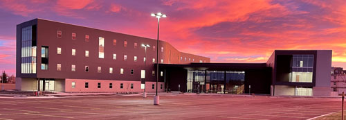 exterior image of LCCC's residence hall with a sunset