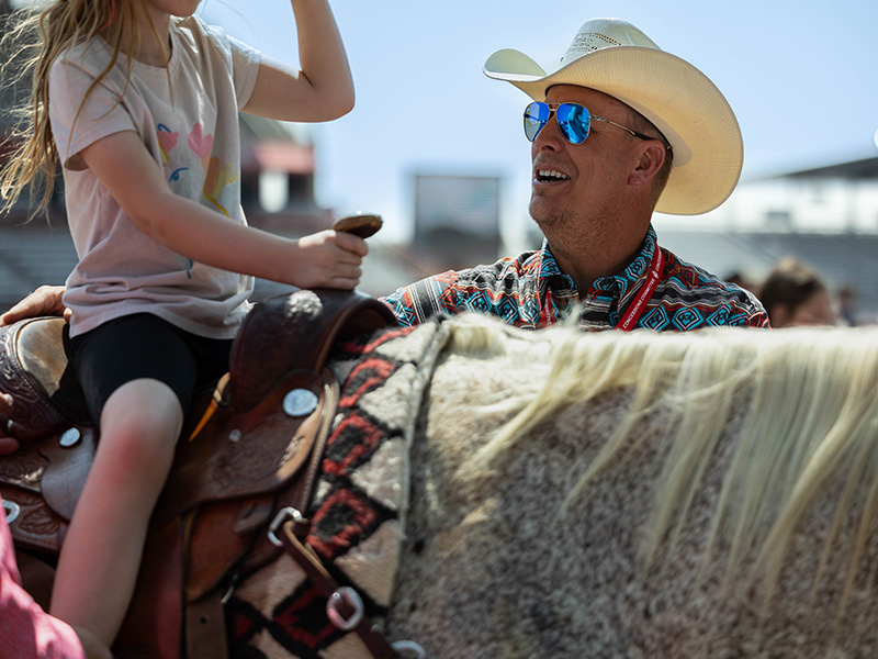 CFD volunteer and LCCC staff member Rick Evelo helps a child during the Challenge Rodeo. 