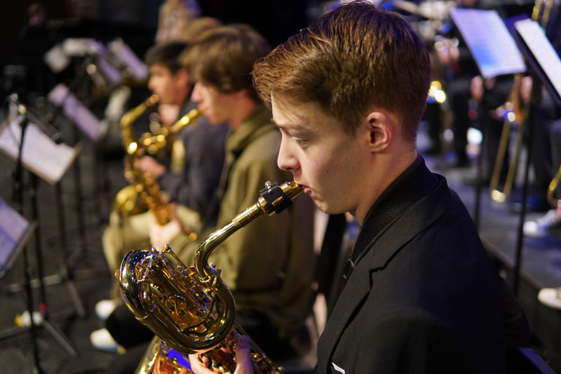 Student playing a saxaphone in a concert