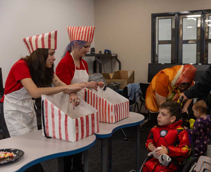 Trunk or treat at LCCC with people handing out candy to children in costumes