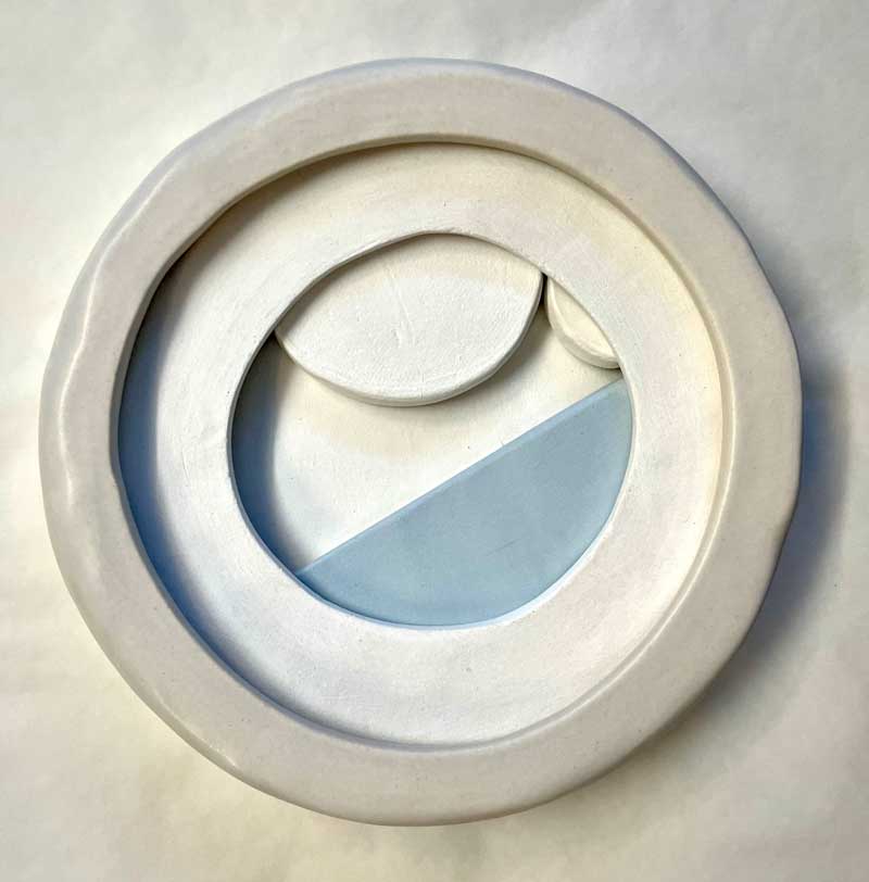 Circular clay artwork by Bronwyn Minton