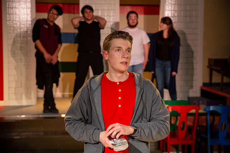Laramie County Community College student Brandon Brown plays the part of Christopher Boone as actors In the back from left to right are Avery Deary, James Brown, Jedediah Huntzinger and April Sandoval-Eaton speak in the upcoming production of 'The Curious Incident of the Dog in the Night-Time.' during rehearsal on campus in April of 2019. 