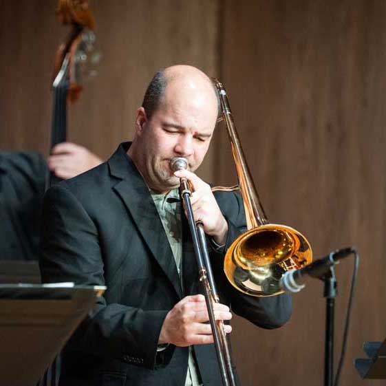 Photo of LCCC Music Faculty playing on stage with a trambone
