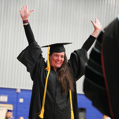 A student at graduation celebrating
