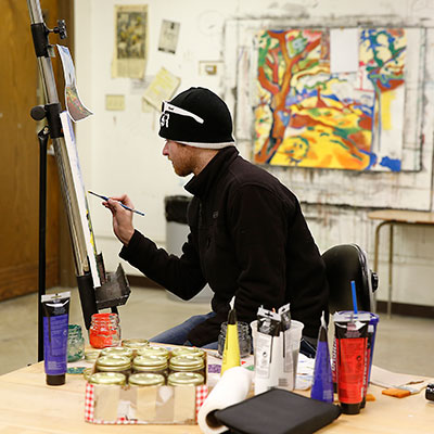 Art student painting in class