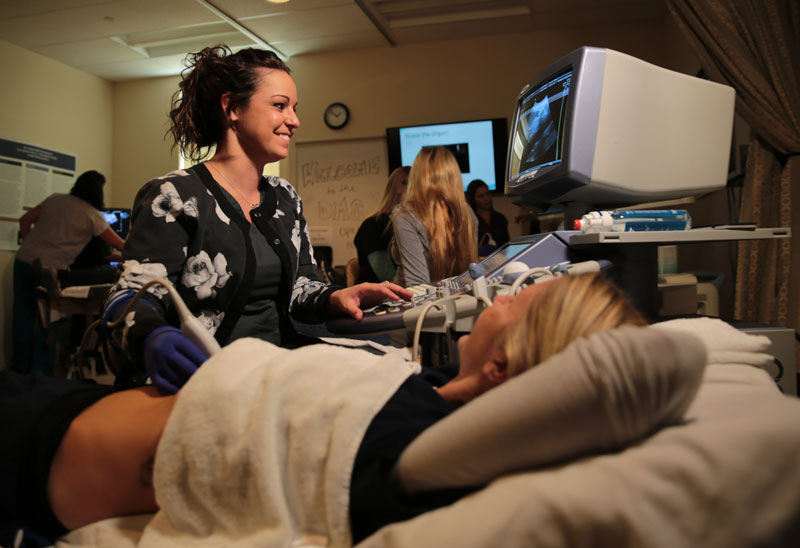 Sonography student practicing on another student