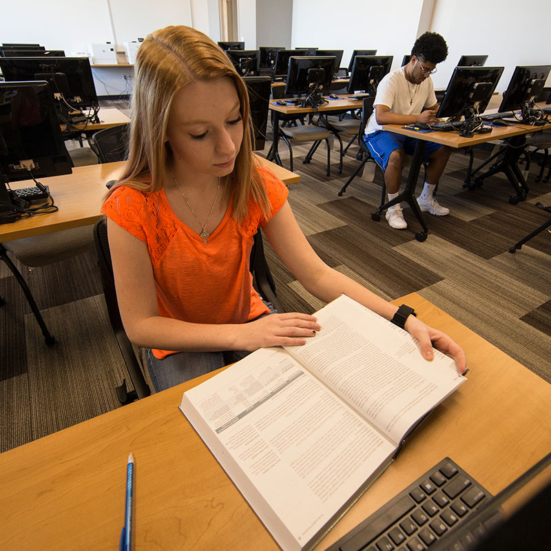 two students studying in a computer lab on campus
