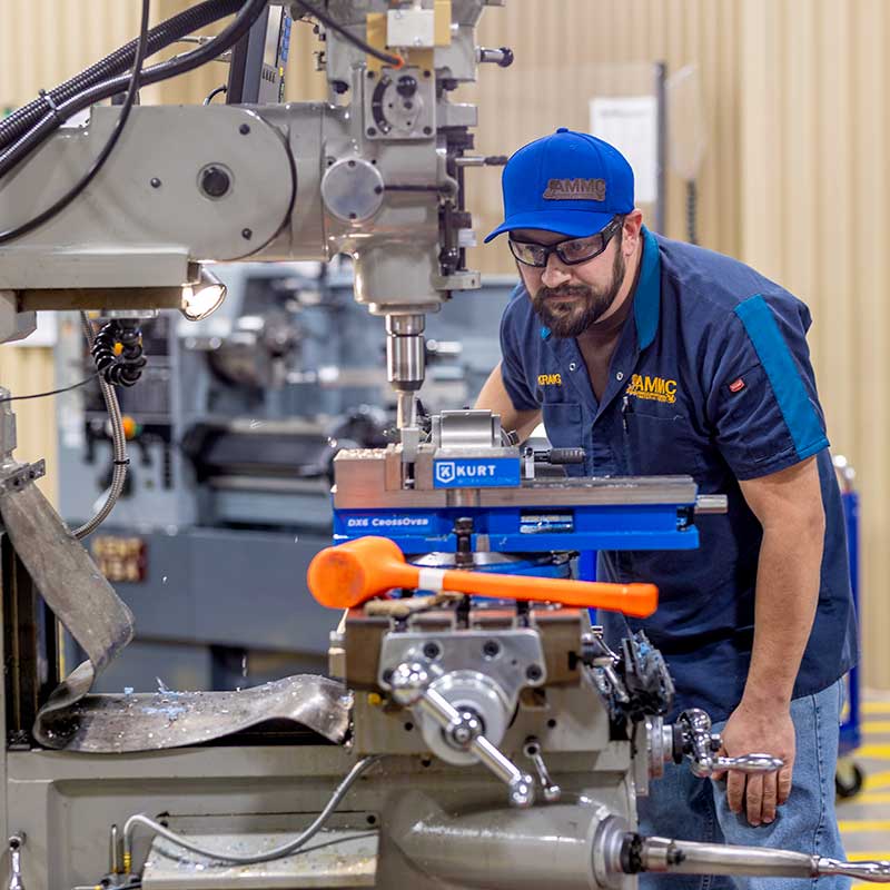 person working with machines in the Advanced Manufacturing & Material Center