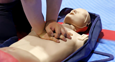 Chest compressions being performed on a CPR practice torso