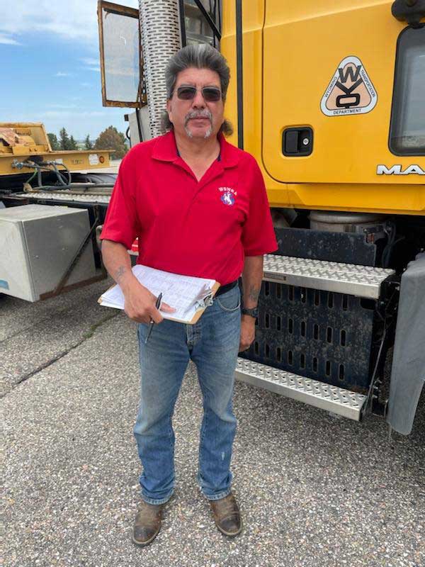 Dennis Pino standing in front of a semi