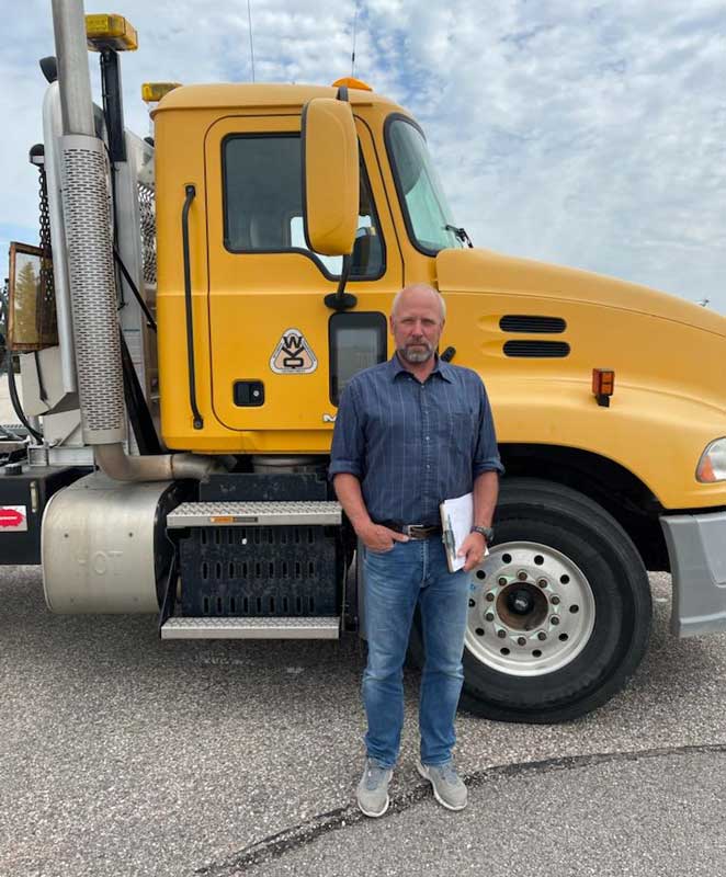Mike Geissler standing in front of a semi