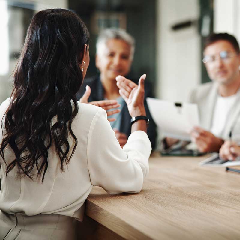 person talking with others in a meeting