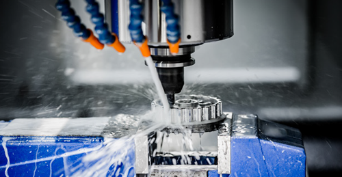 manufacturing machine spraying water and cutting