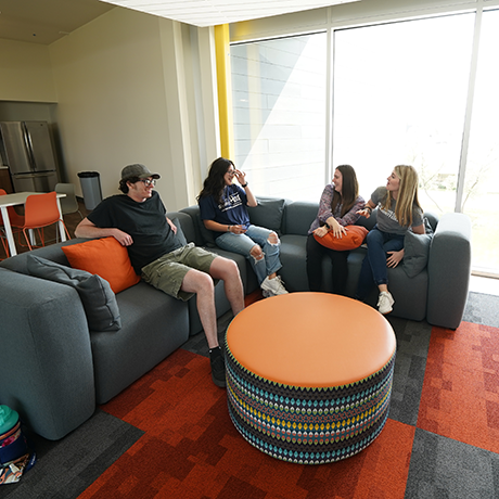 students sitting on a couch in a common area in Gold Hall